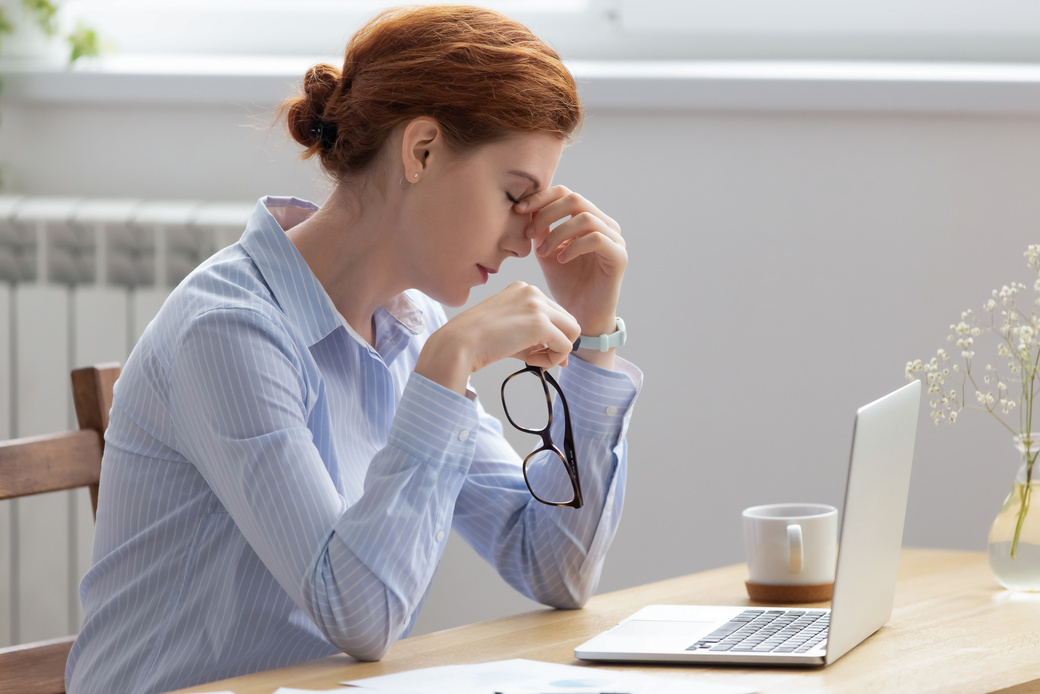 Tired businesswoman taking off glasses, suffering from dry eyes syndrome